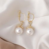 Stunning floral huggie earrings with white pearls and cubic zirconia, set in 18k gold plating for a luxurious touch.